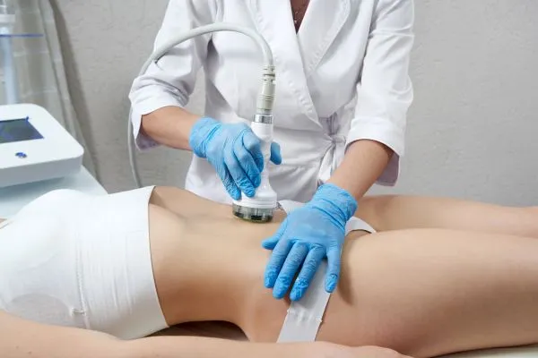 Lost the Weight but Not the Loose Skin? 2 woman having HIFU treatment on her stomach to combat loose skin Horley following weight loss